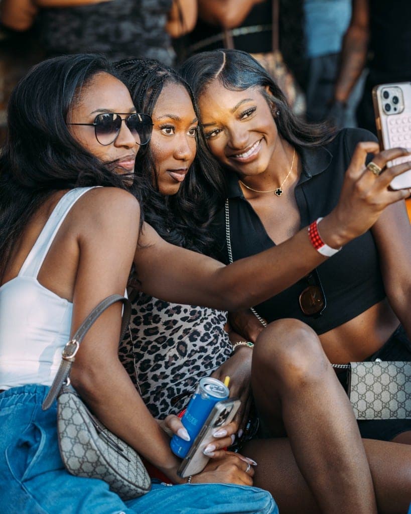 Friends taking a selfie at homecoming
