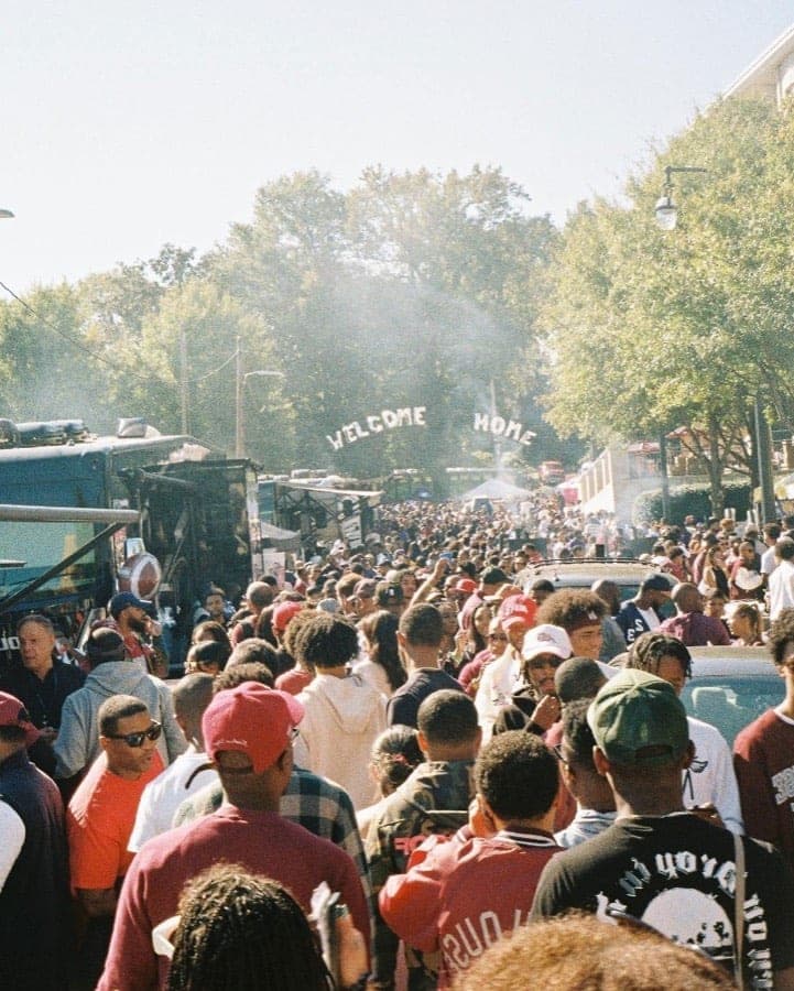 Crowd under the WELCOME HOME banner at SpelHouse homecoming